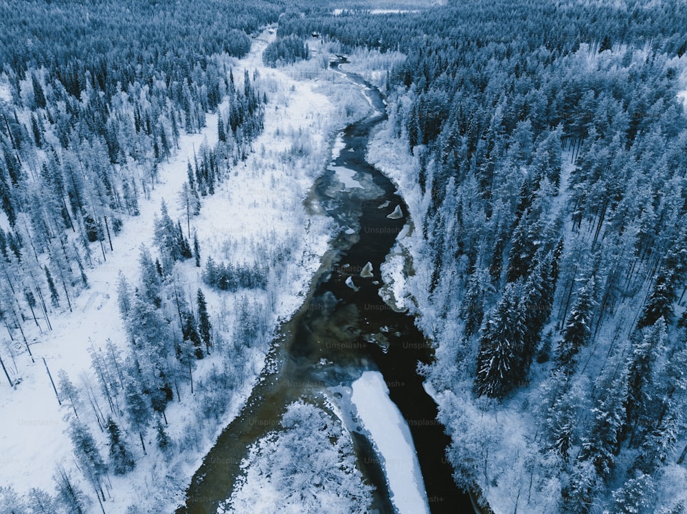 a snowy mountain with a river running through it