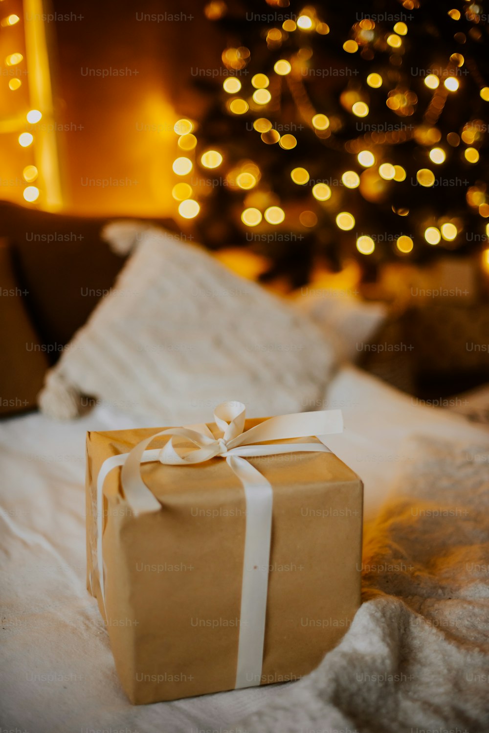 a white gift wrapped in a white wrapper on a white surface