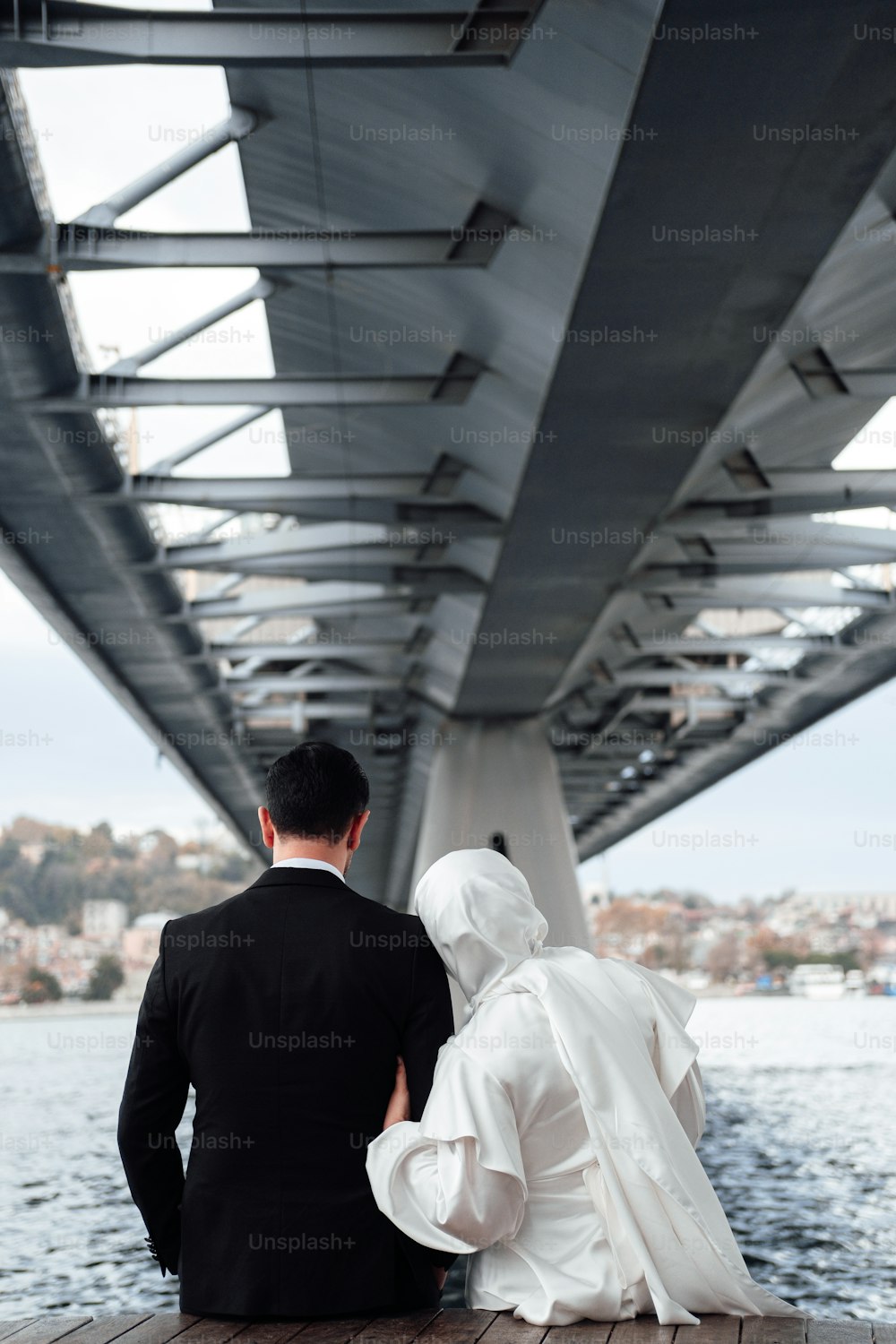 a man and woman under a bridge