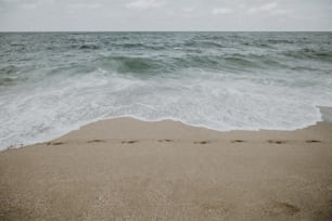 a sandy beach with waves crashing