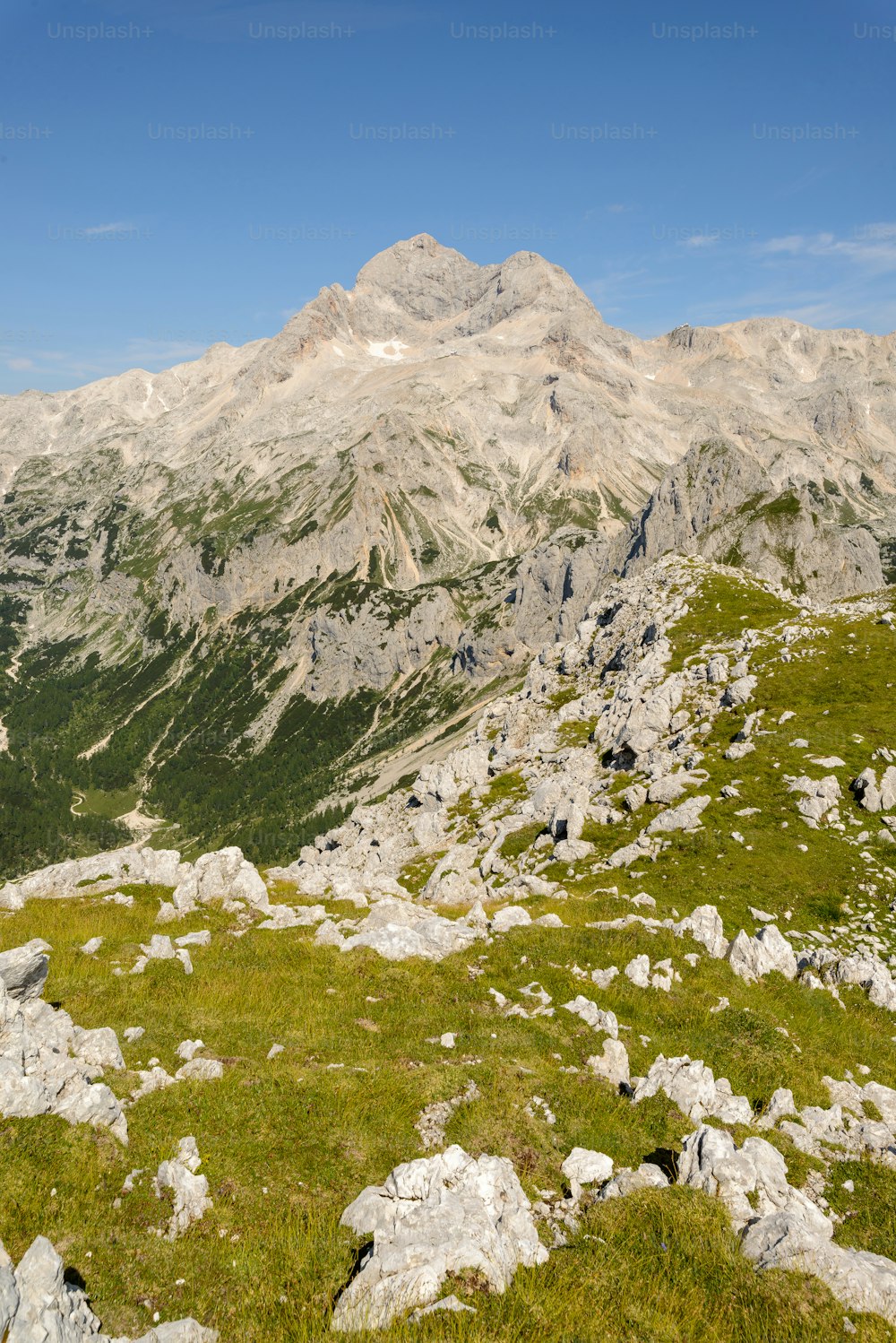 uma montanha rochosa com grama e rochas