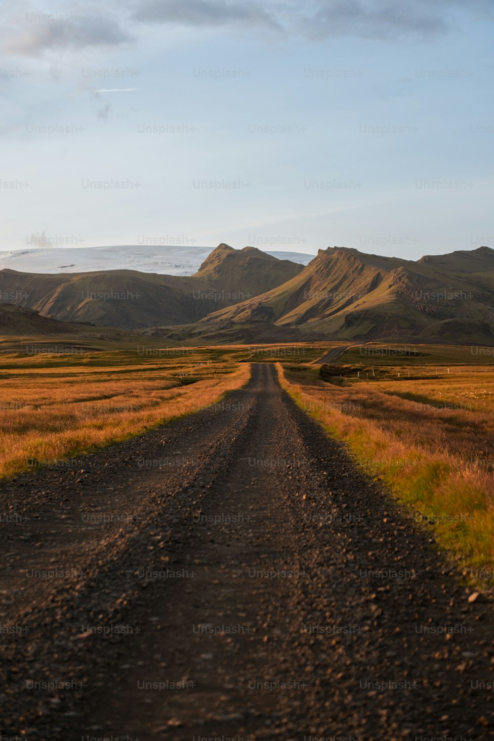 a dirt road leading to a mountain