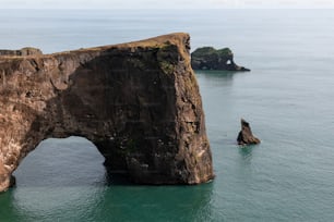 a rock formation in the middle of the ocean