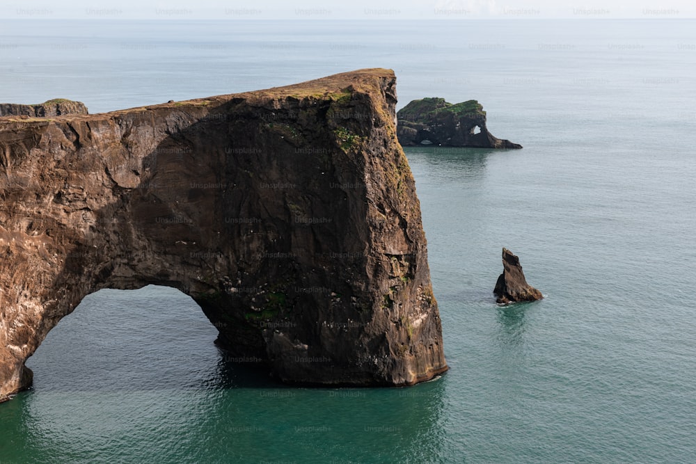 a rock formation in the middle of the ocean