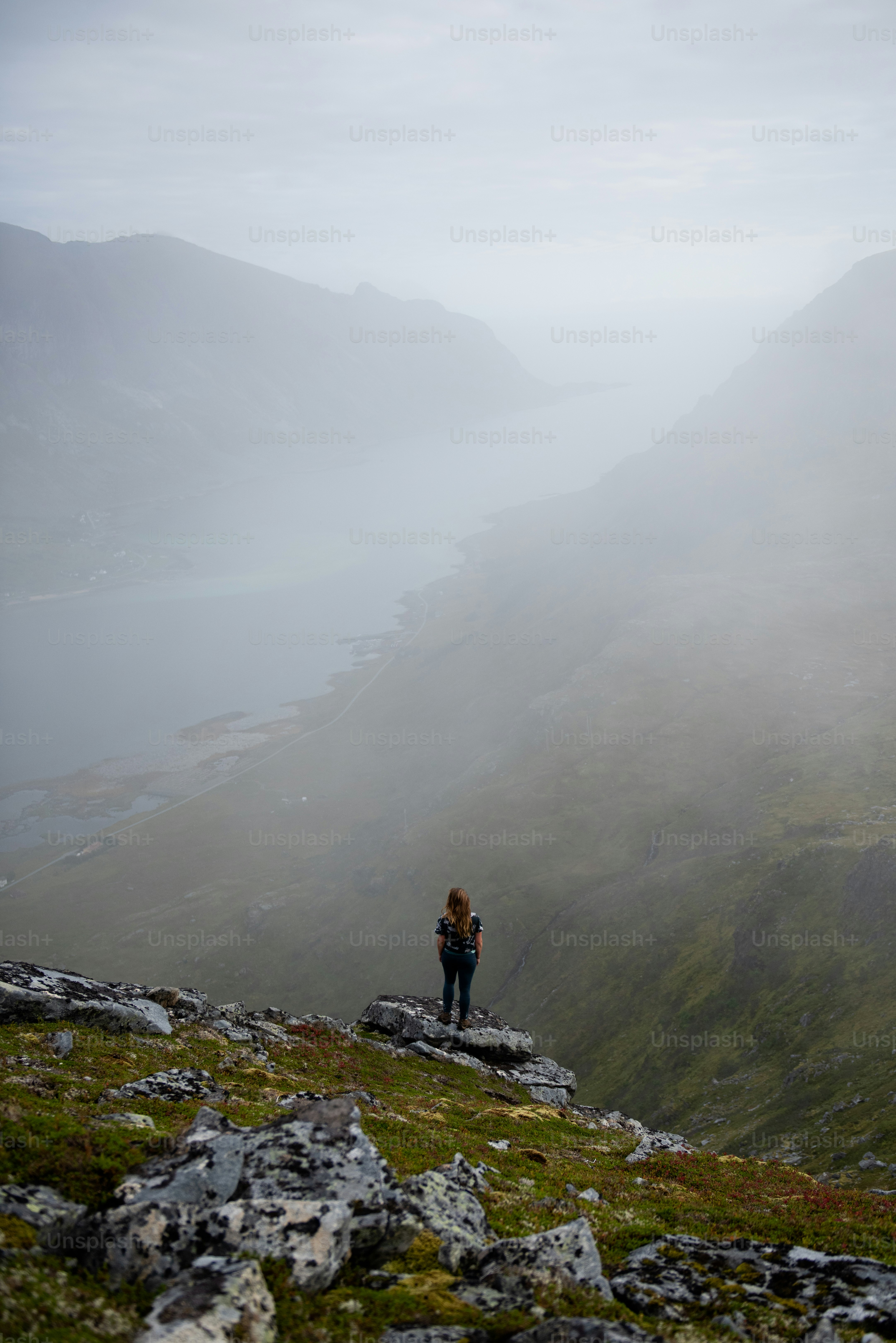 a man standing on a rocky hill