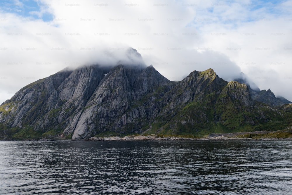 a body of water with a mountain in the background