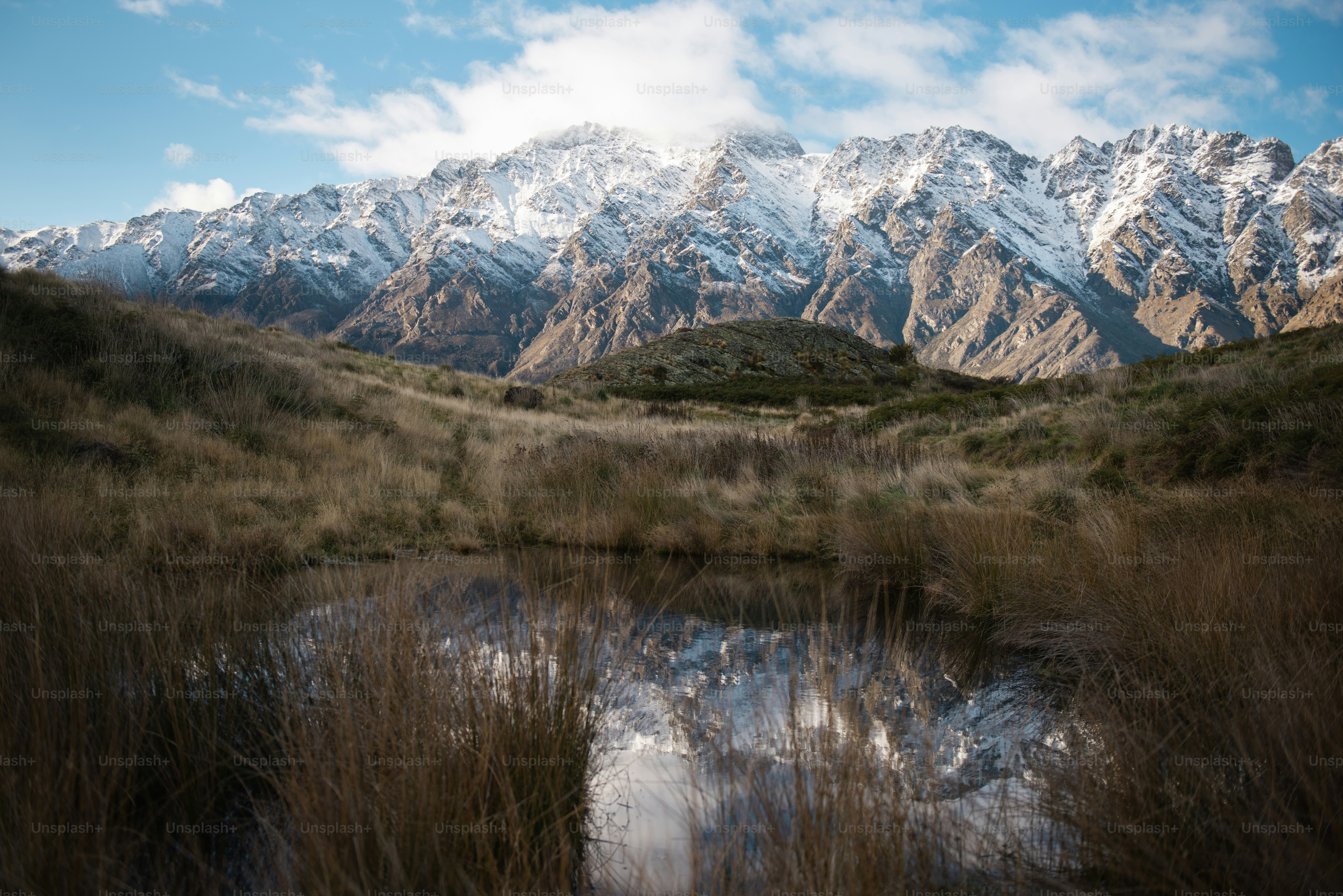 a lake in front of a mountain range