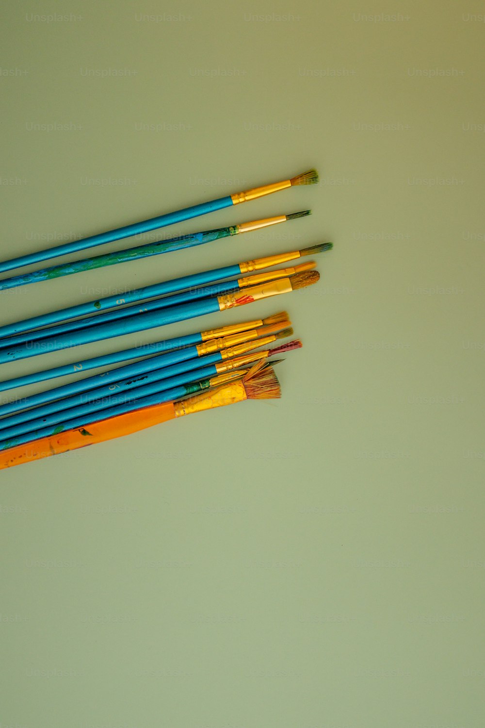 a group of colored pencils