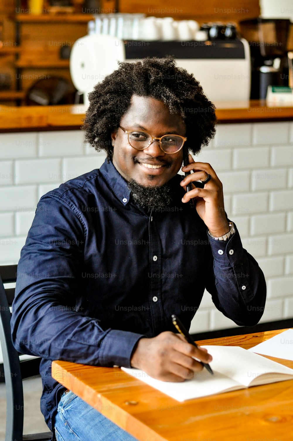 a man holding a pen and a paper