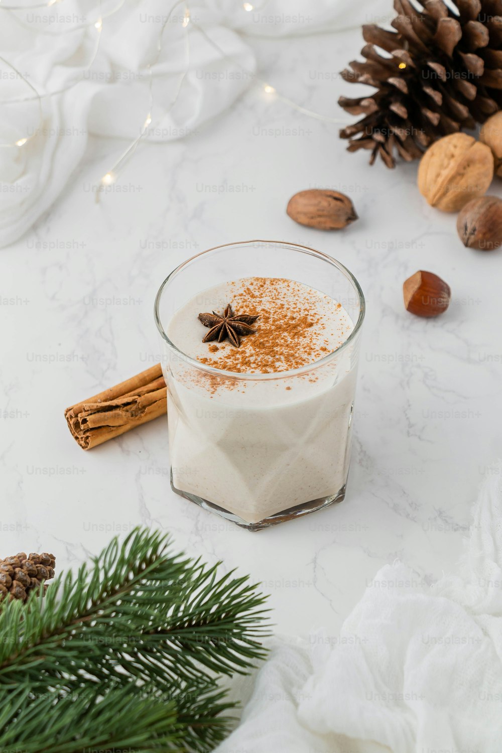 a glass of milk with a pine cone and a pinecone