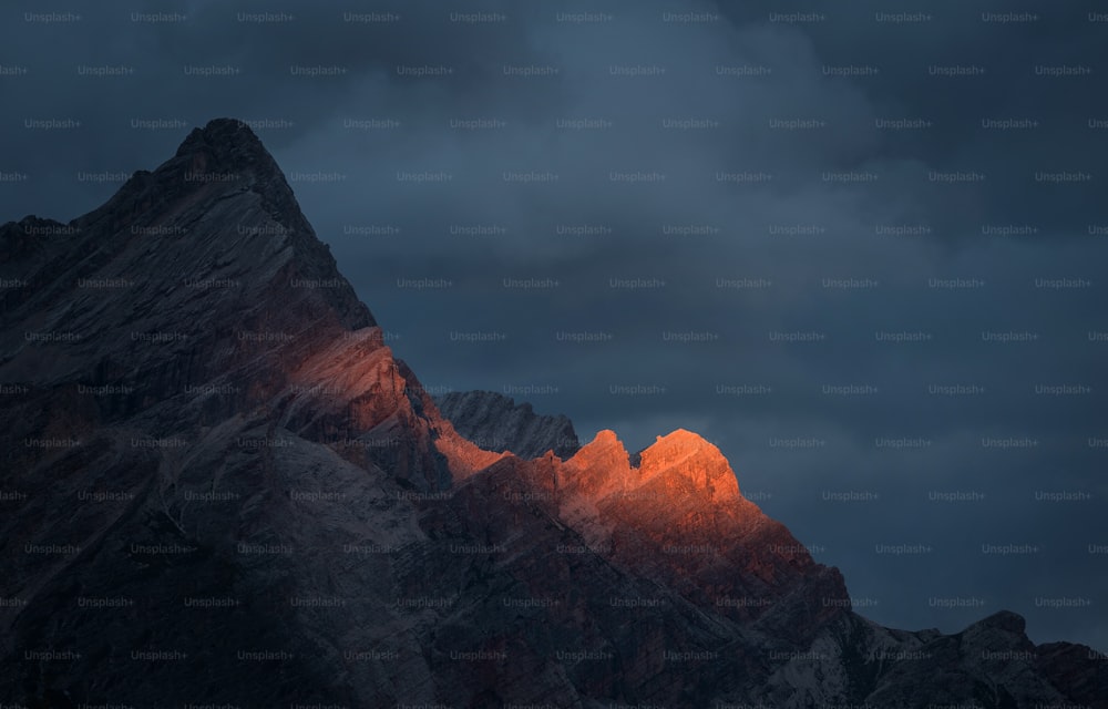 a mountain with a cloudy sky
