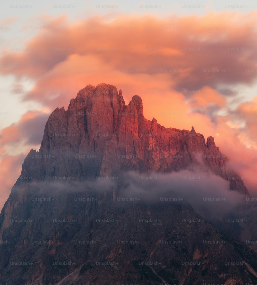 a mountain with clouds below