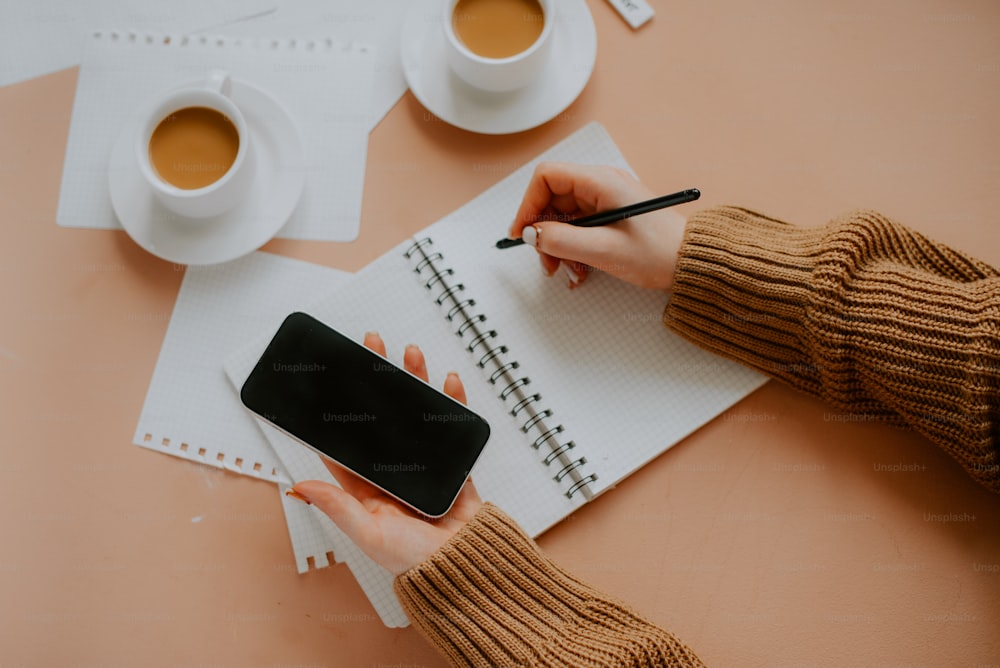 a table with a phone and coffee