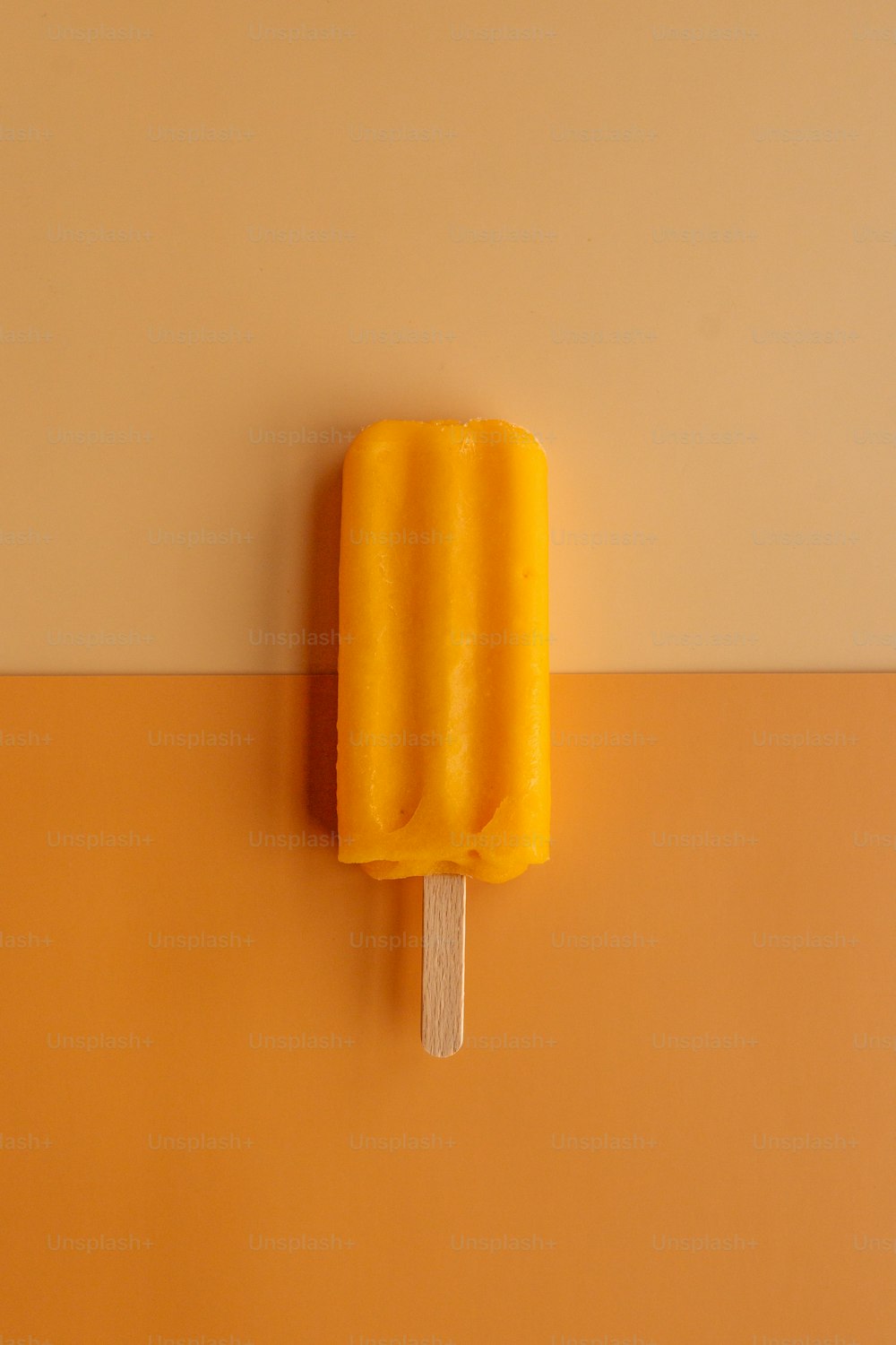 a yellow eraser on a wall
