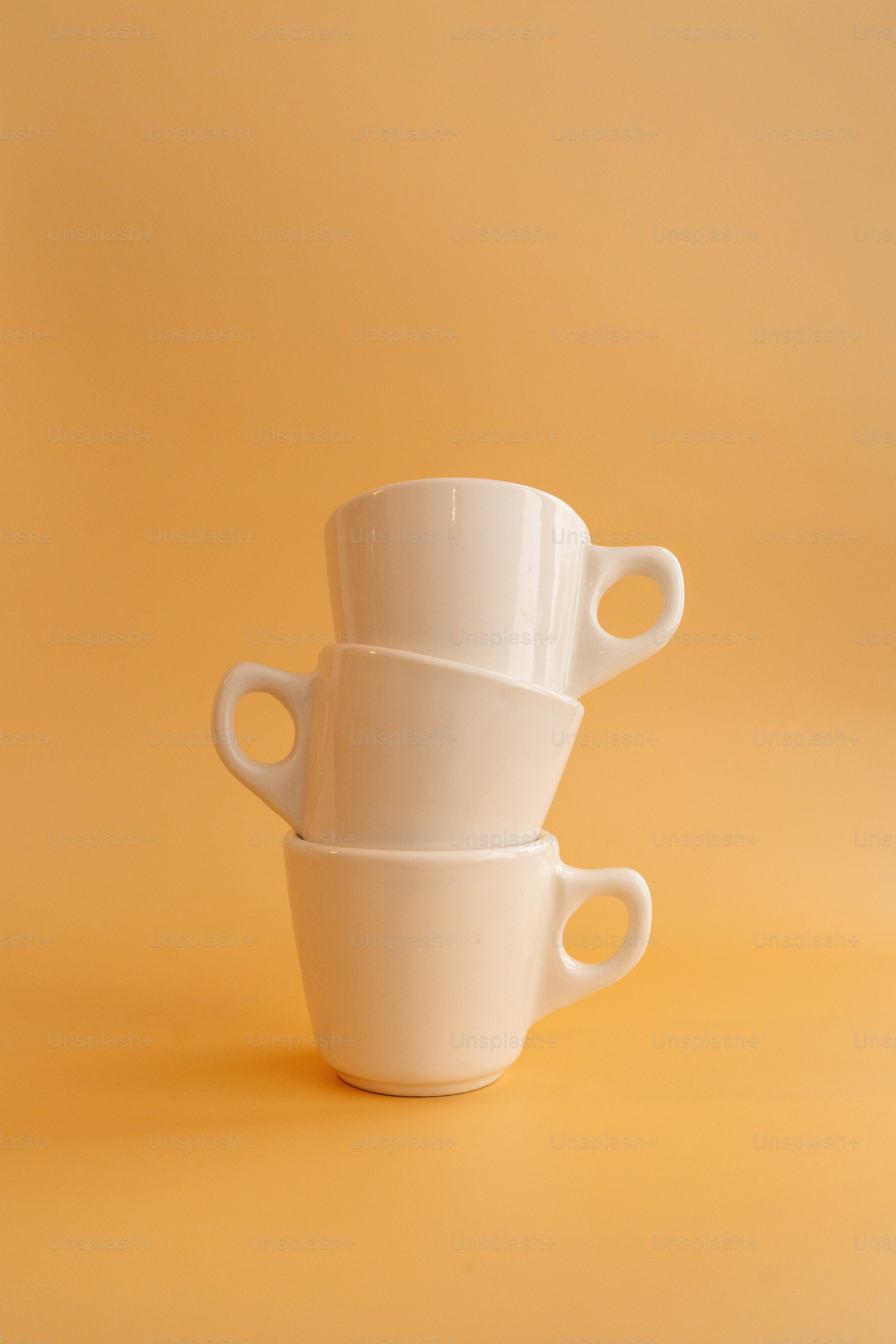 a white teapot on a white surface