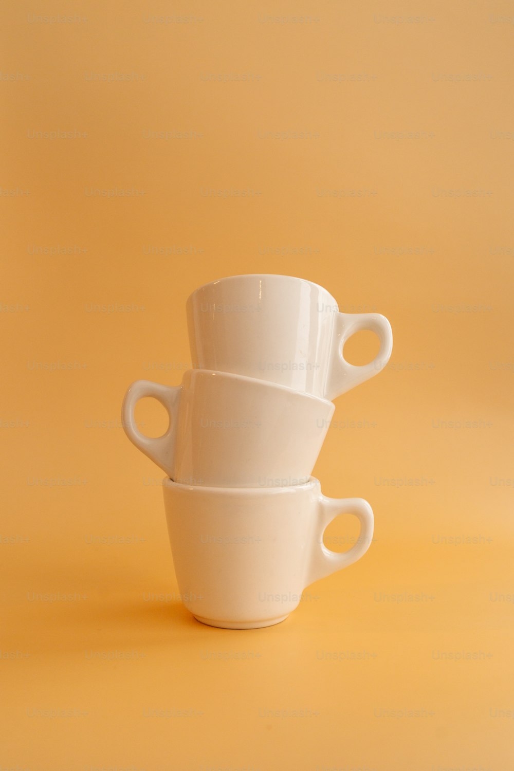 a white teapot on a white surface