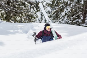 a person sitting in the snow with skis