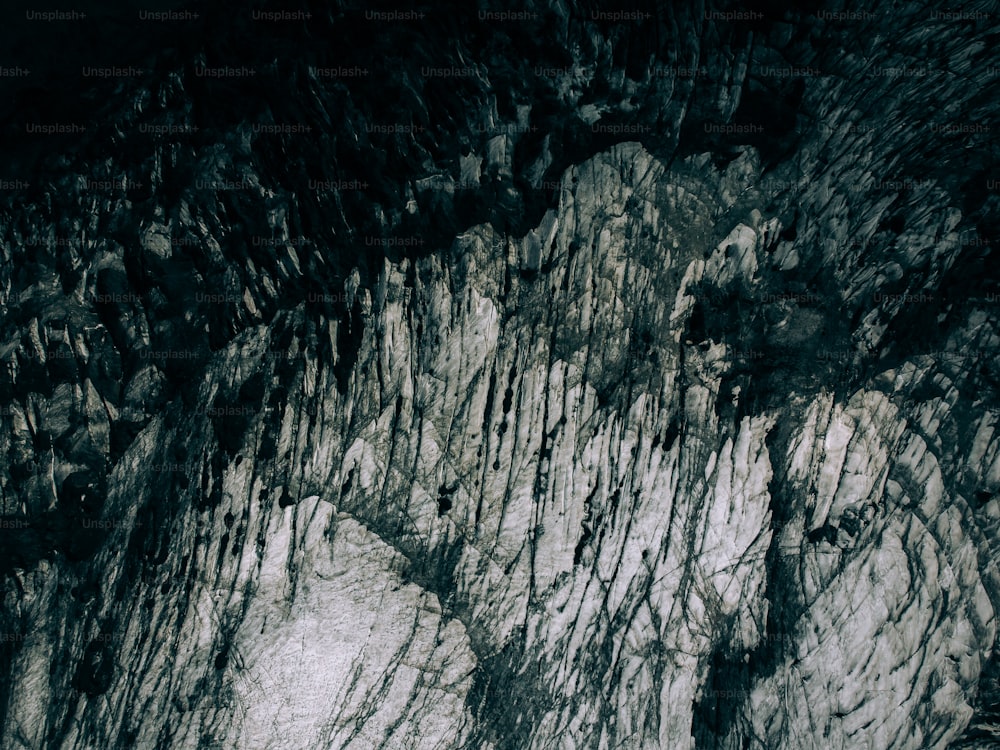 a rocky cliff with green plants