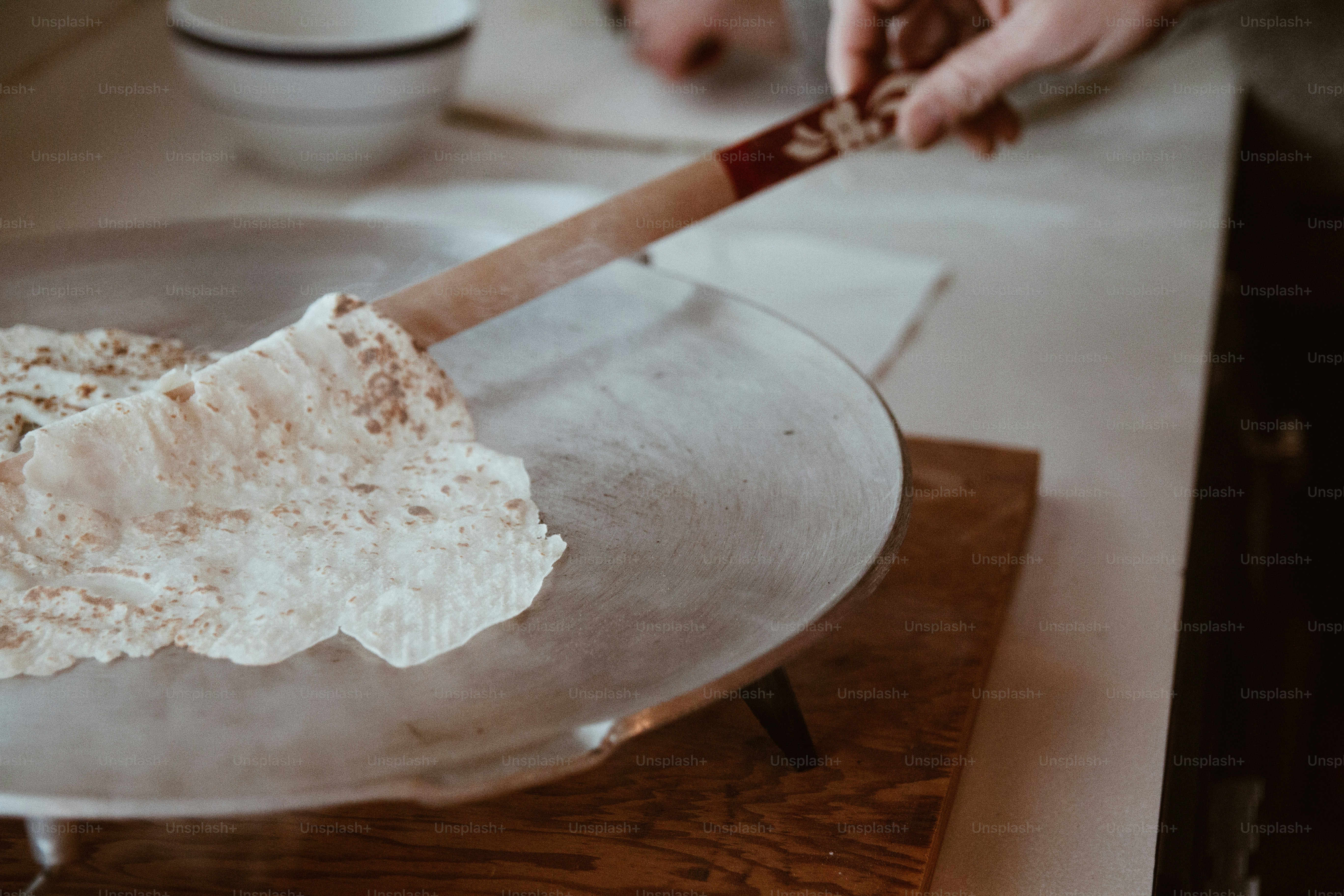 a person cutting a cake