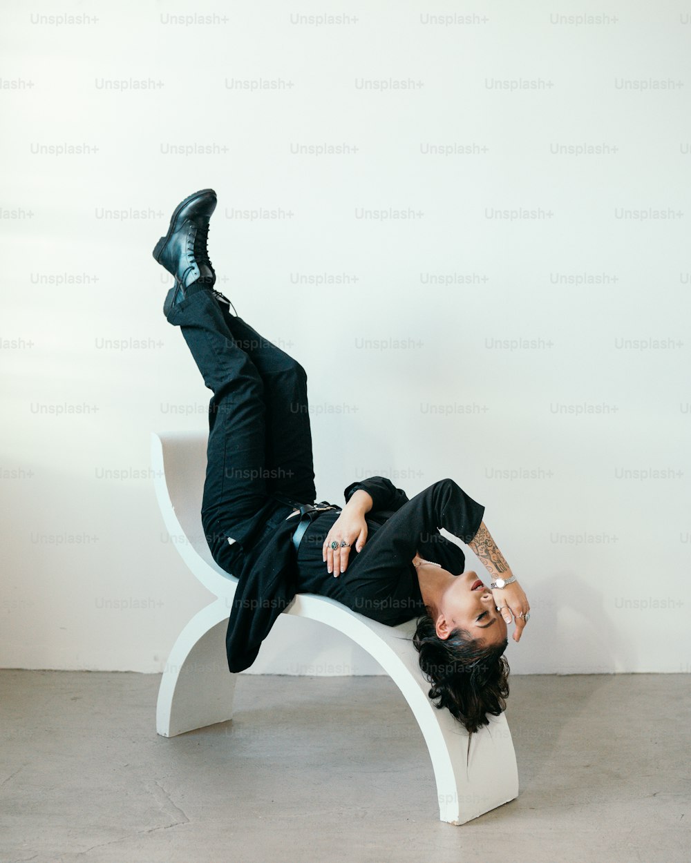 a person lying on a white chair
