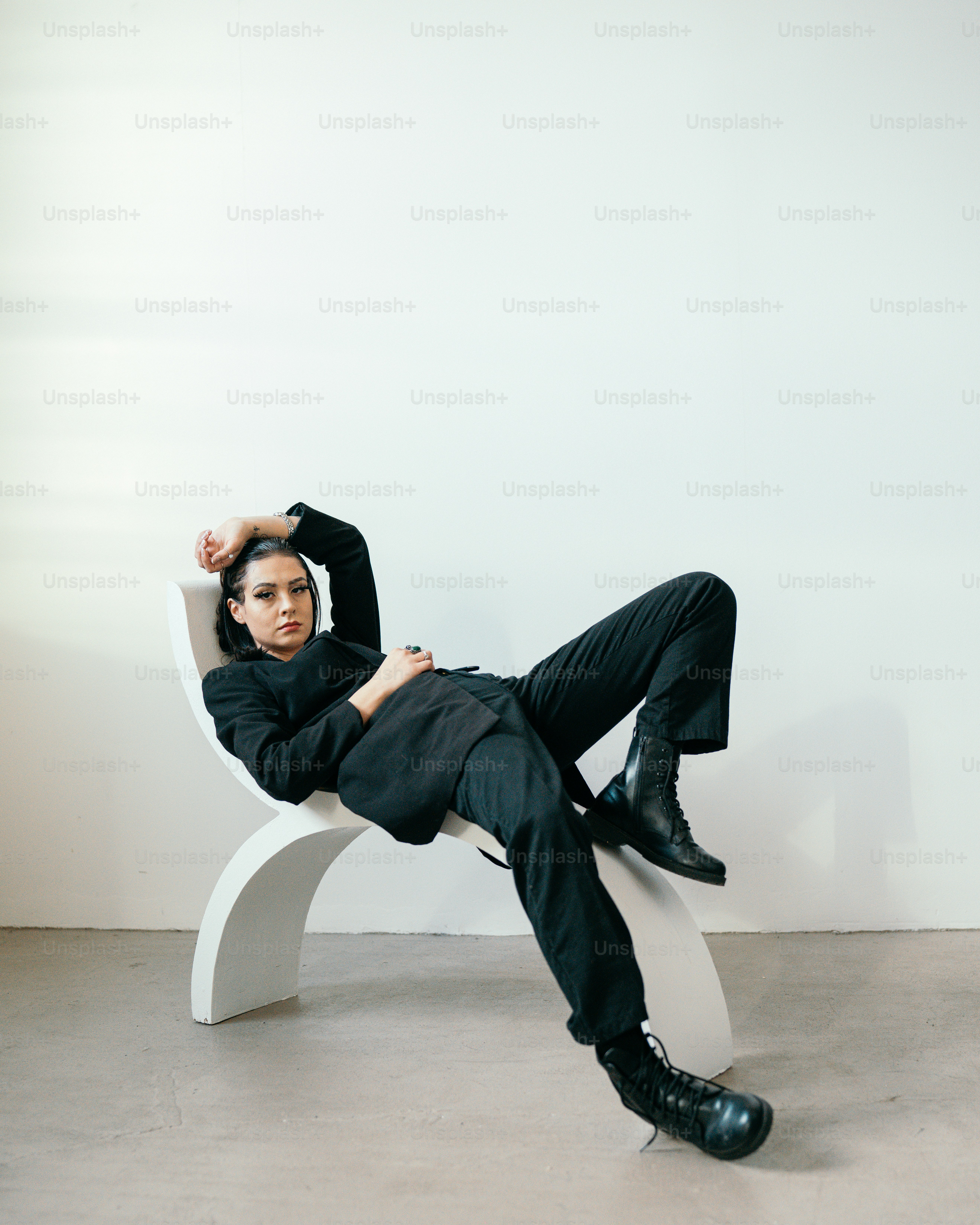 a person lying on a white bench