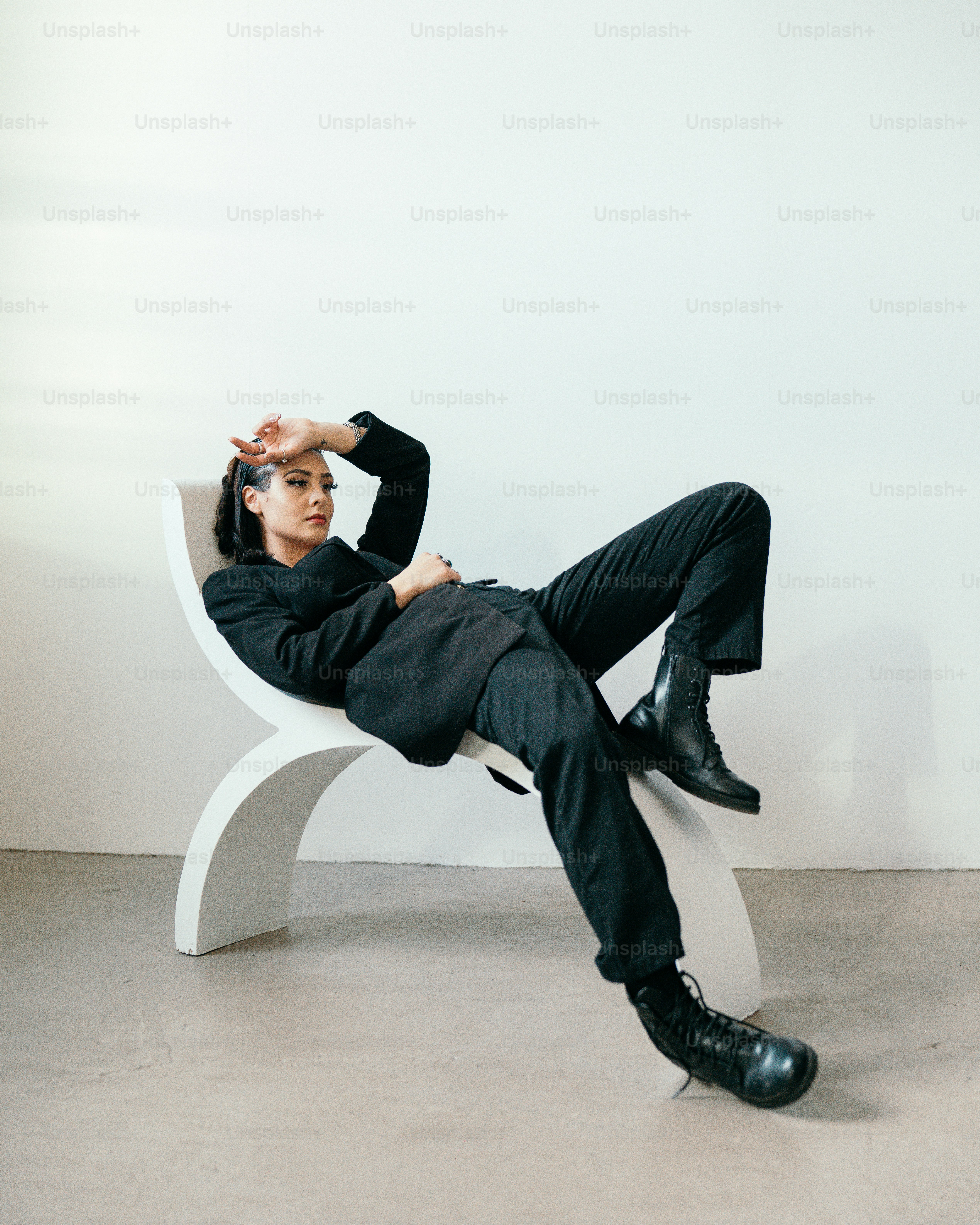 a woman lying on a white bench