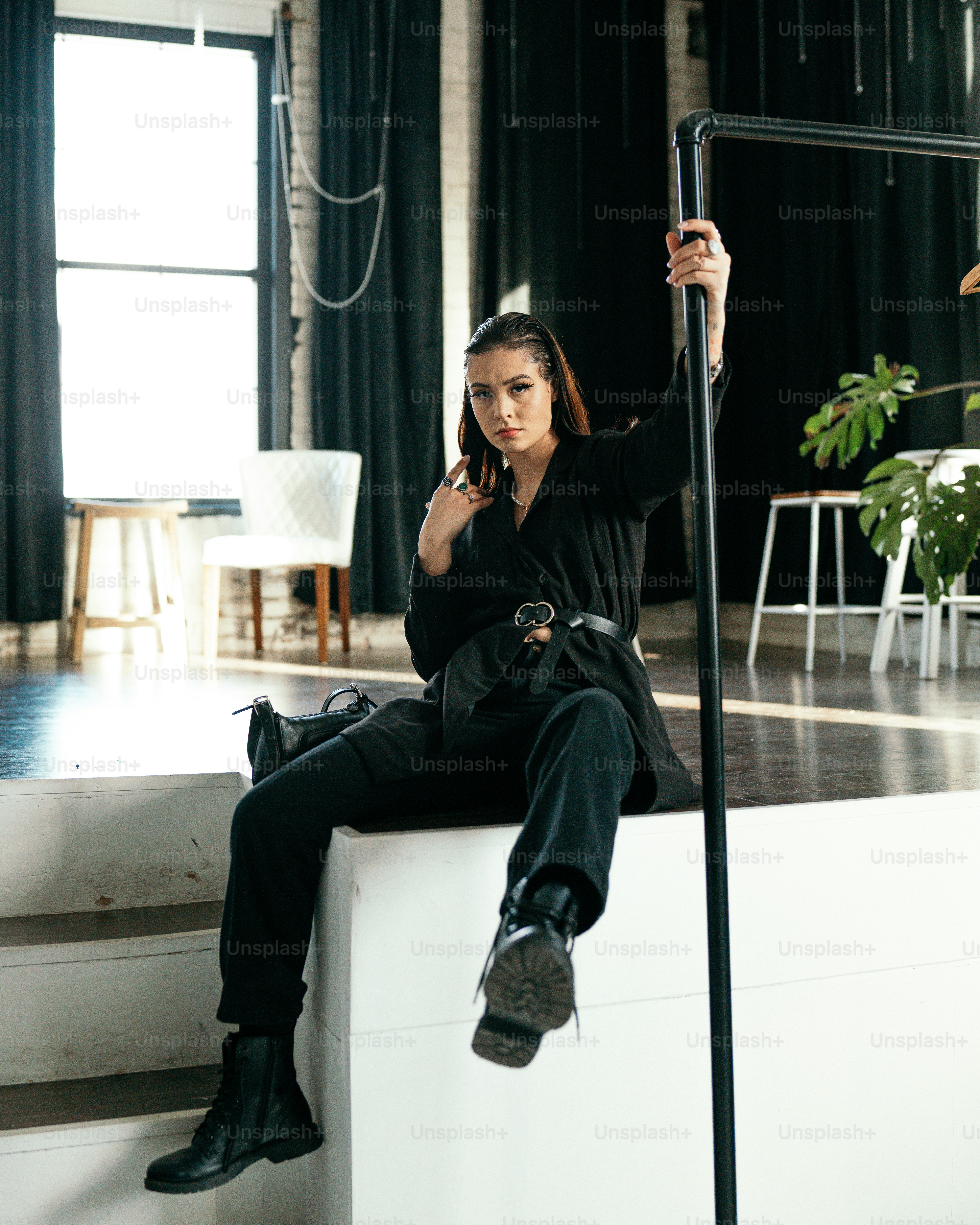 a man sitting on a chair holding a microphone