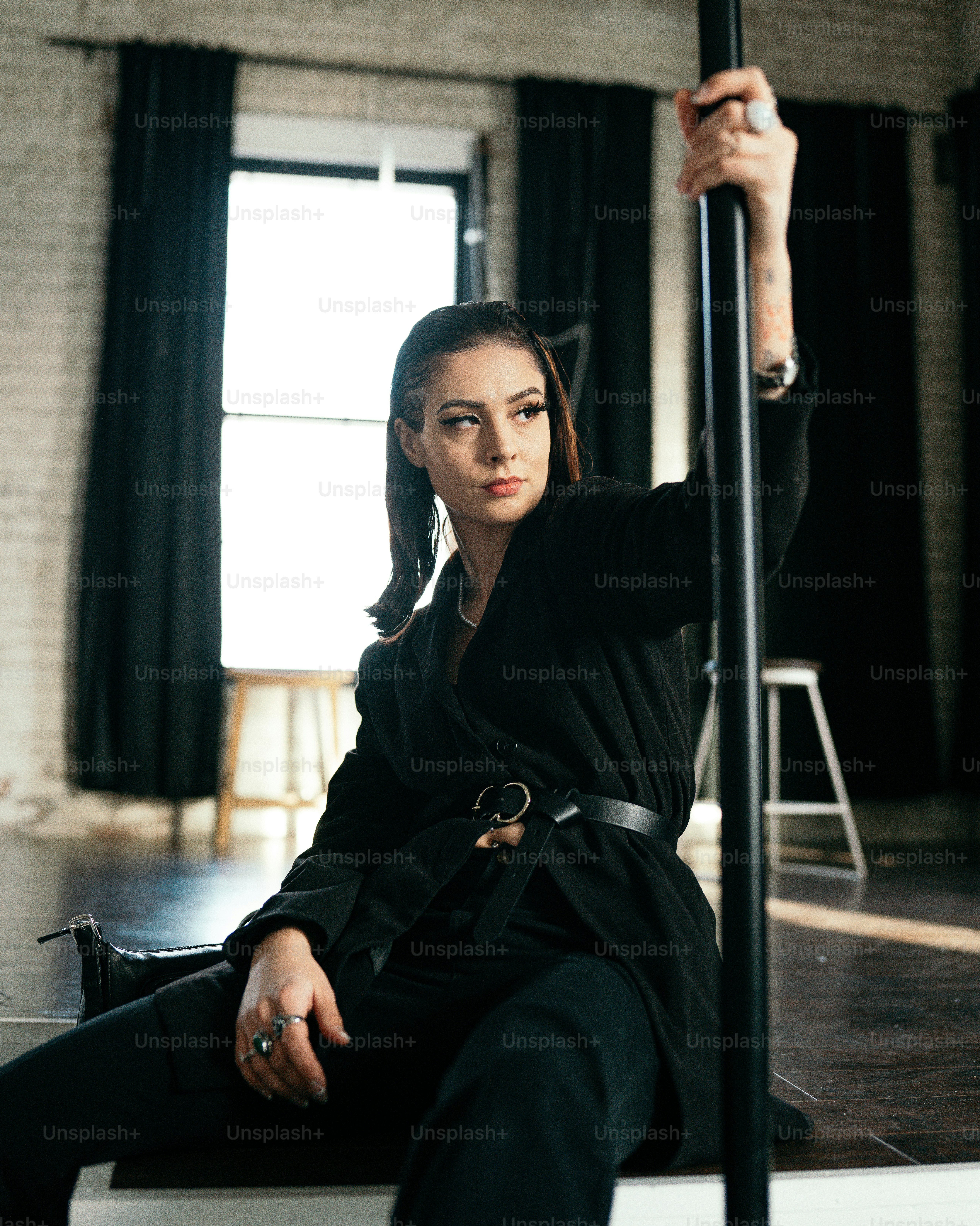 a person sitting on a chair holding a pole