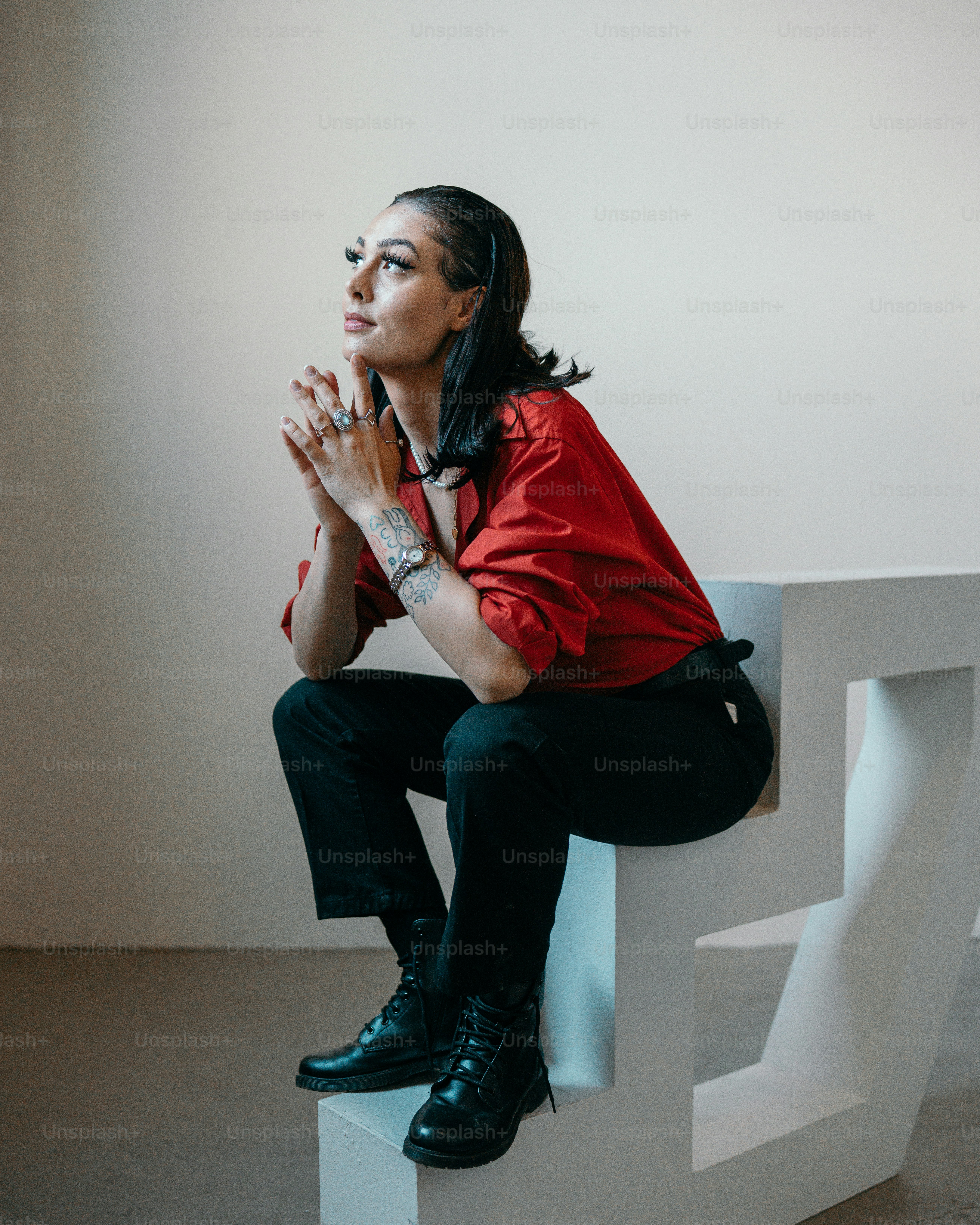 a woman sitting on a white bench