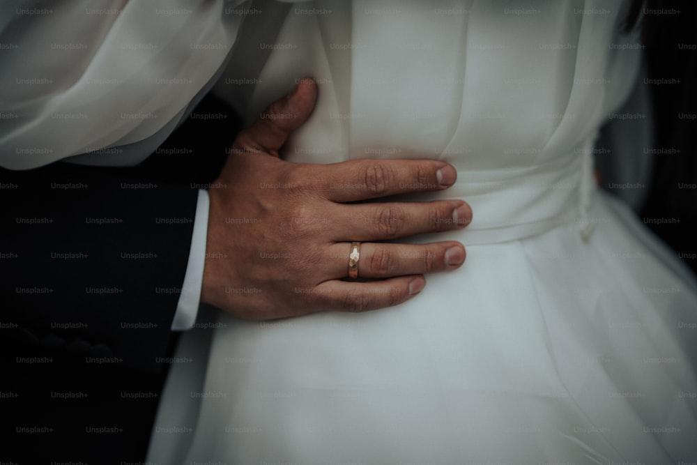 a close up of a person wearing a wedding ring