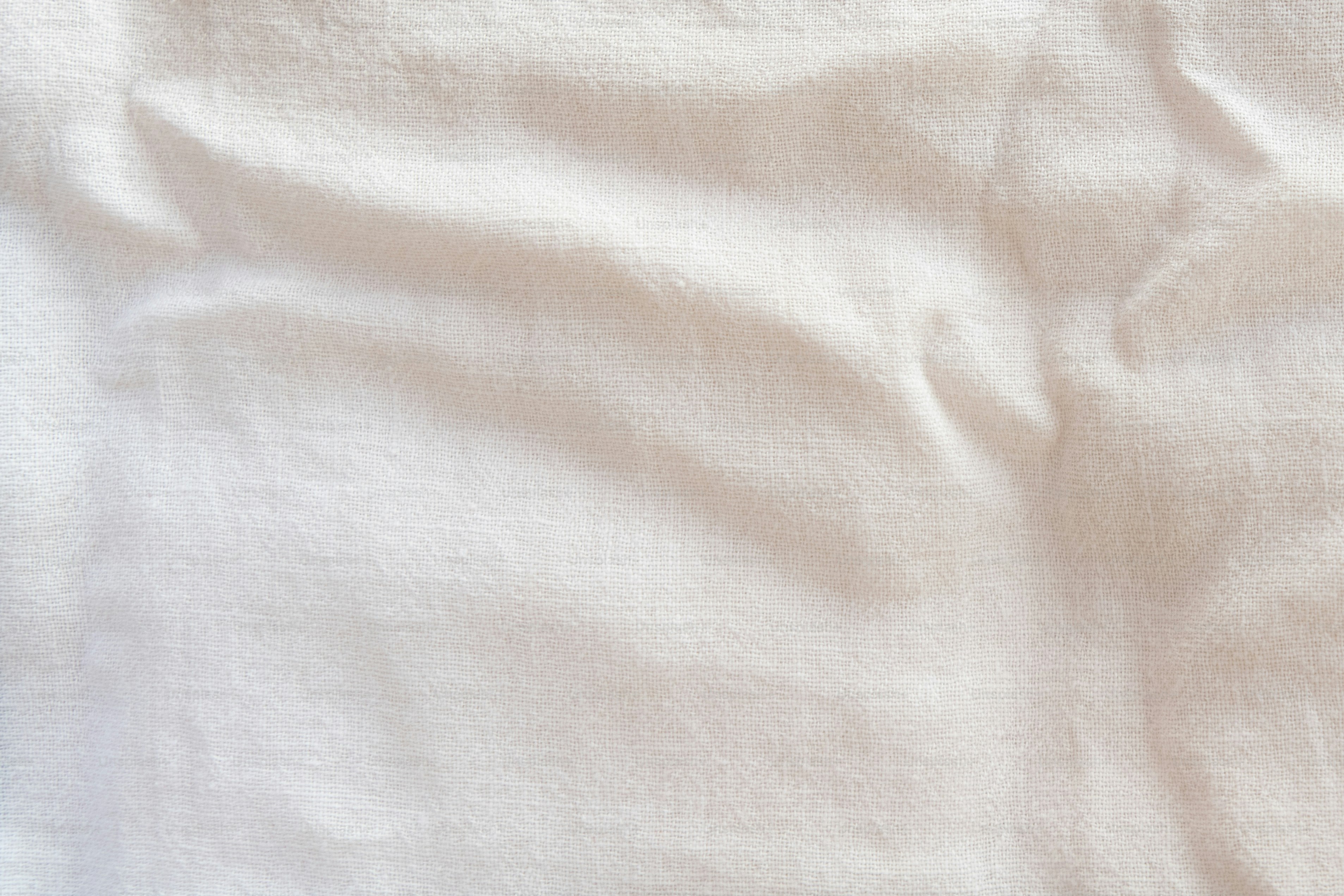 a close up of a white sheet on a bed