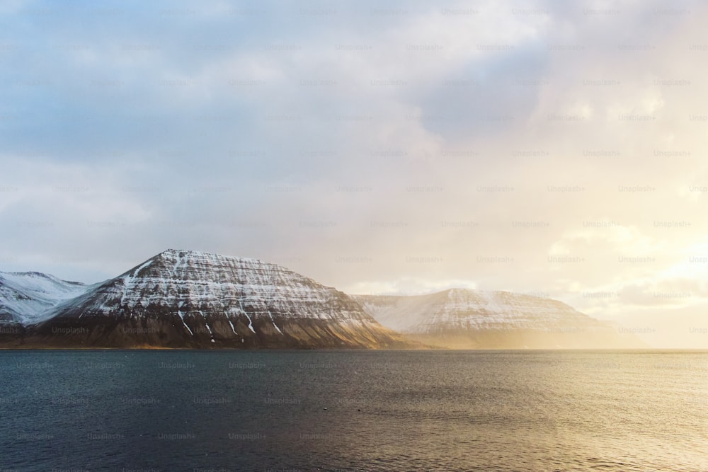 a body of water with a mountain in the background