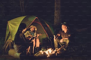 Friends are camping in the night.