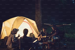 Friends are camping in the night.