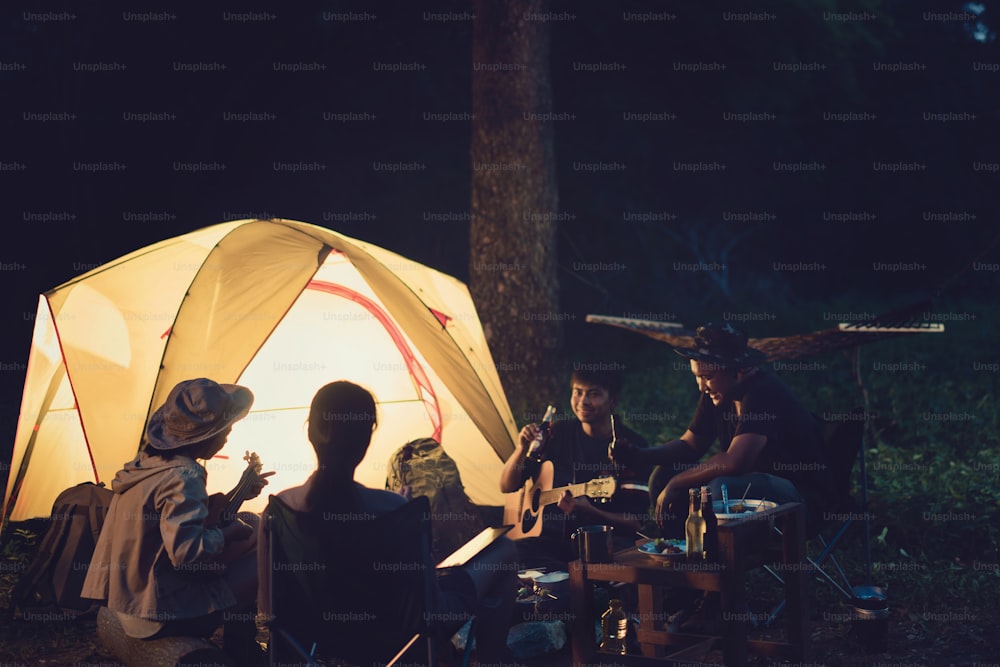 Friends are camping in the night.