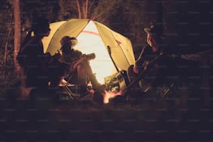 Friends are camping in the night.