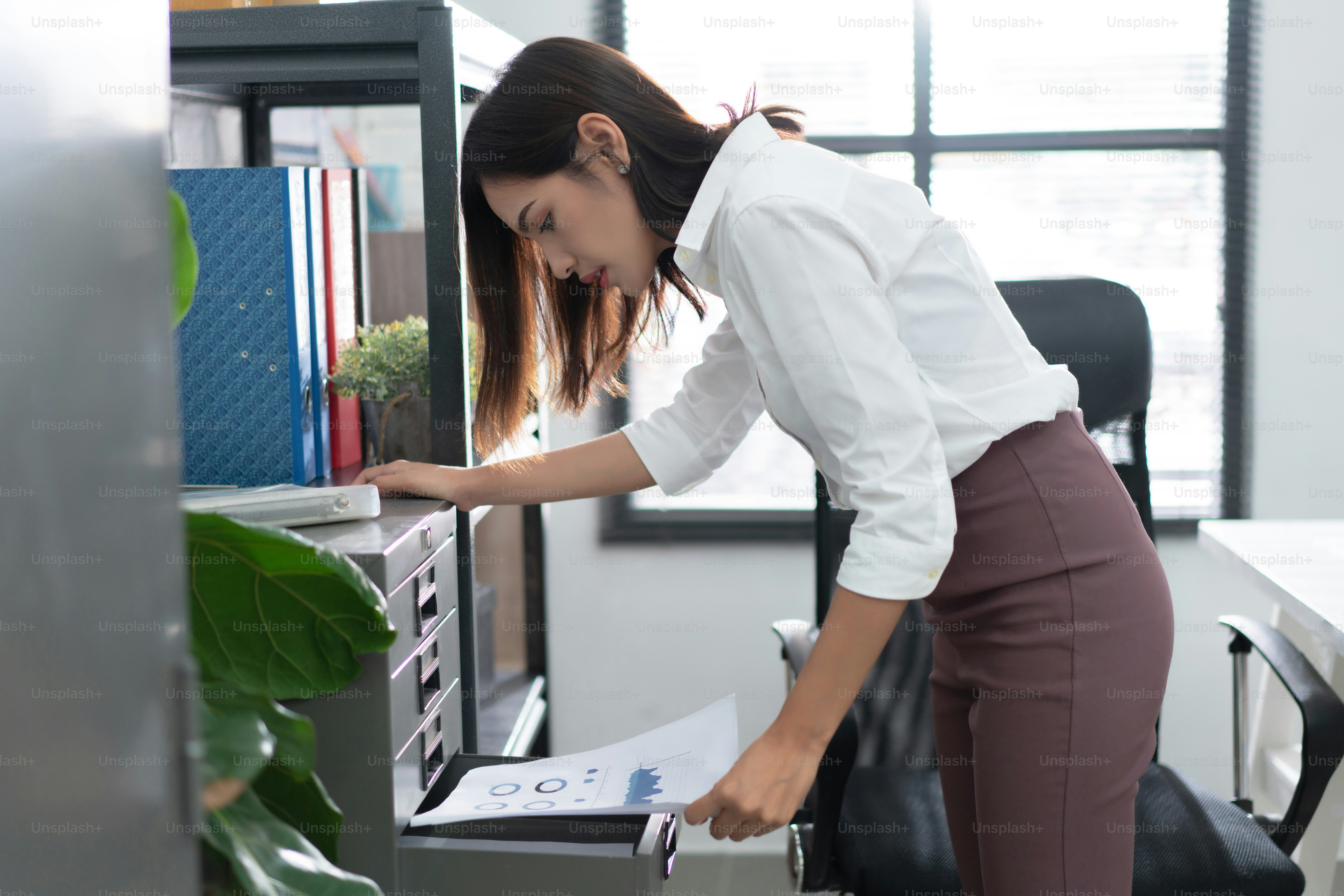 Asian women Viewing documents in the office.