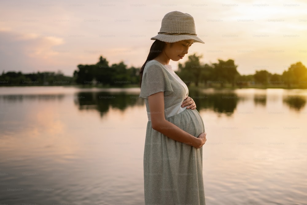 Pregnant woman walks in the park she feels relaxed