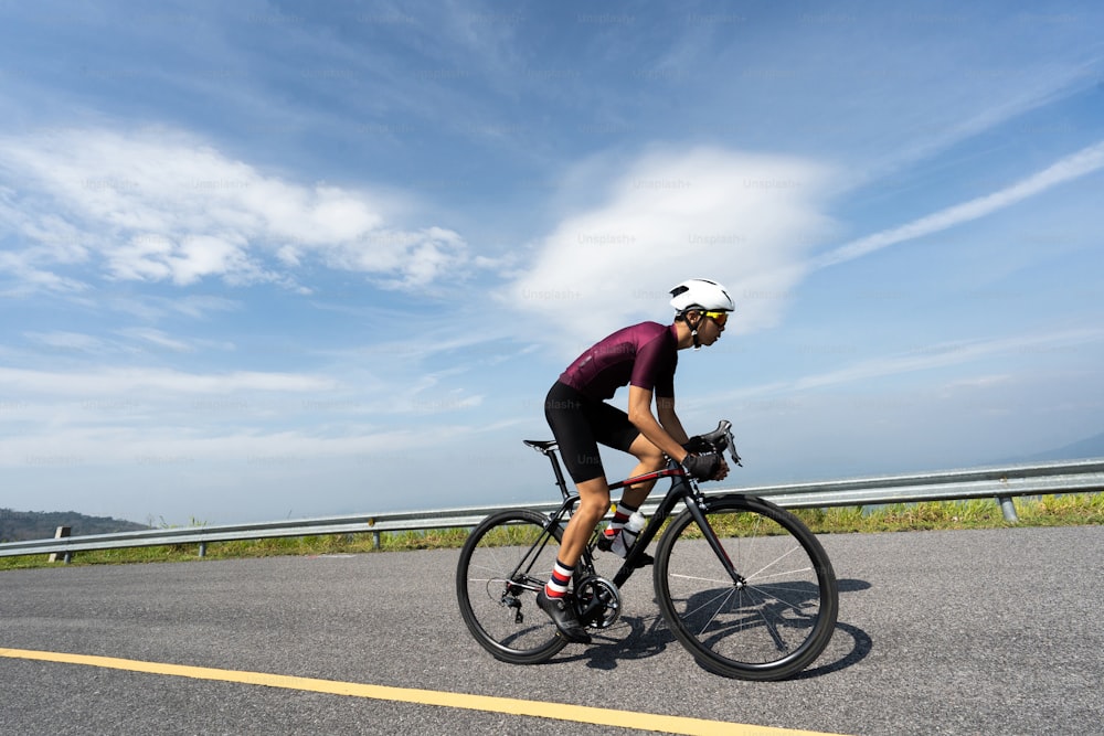 Asian man cycling road bike in the morning