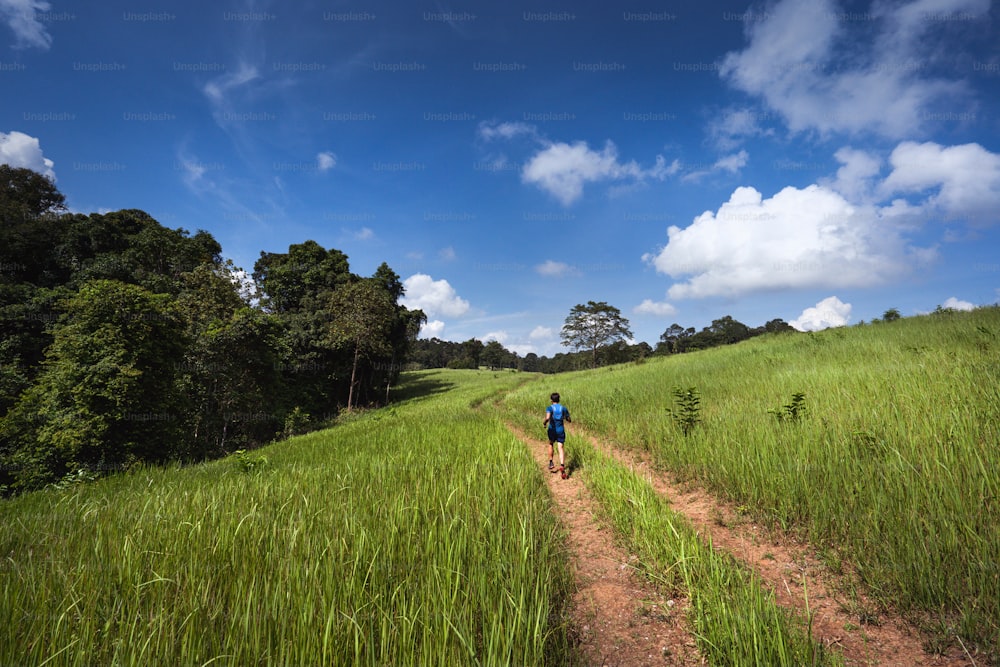 Asian men are running a trail In the natural path