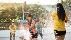 Asian people are using water guns play songkran festival in the summer april