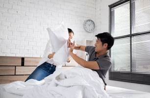 Asian couple in bed, they quarrel. they are unhappy and stress