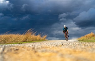 Cyclists practicing on gravel roads in bad weather day