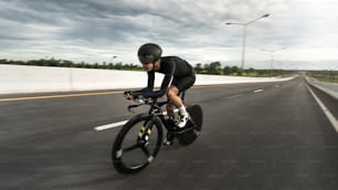 Asian men are cycling "time trial bike" in the morning