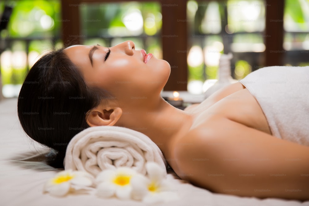 Donna asiatica che ha un concetto di trattamento di bellezza con massaggio e salone spa. È molto felice