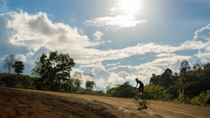 Cyclists practicing on gravel roads He is riding, climbing