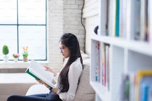 Asian women reading at home.