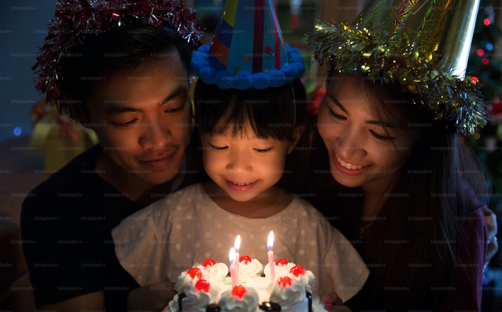 Asian family a birthday party for her daughter's daughter is about to blow out the candles.