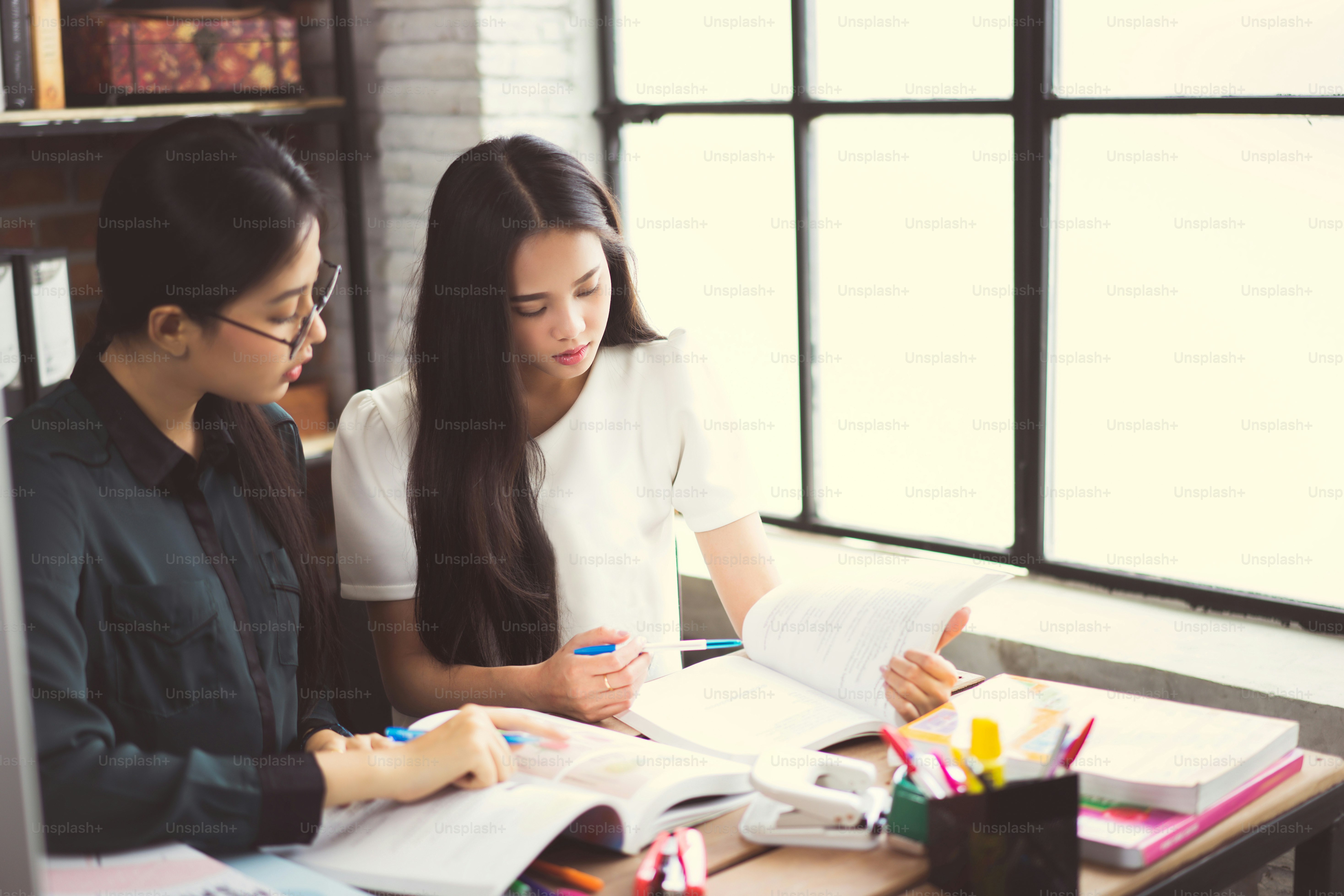 Asian groups are brainstorming, working in the office, reviewing ...