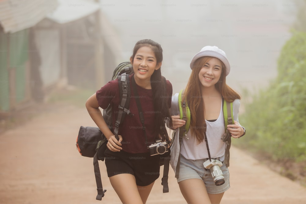 Asian women tourists were excited to see the mist on the mountain, They are smiling happily.